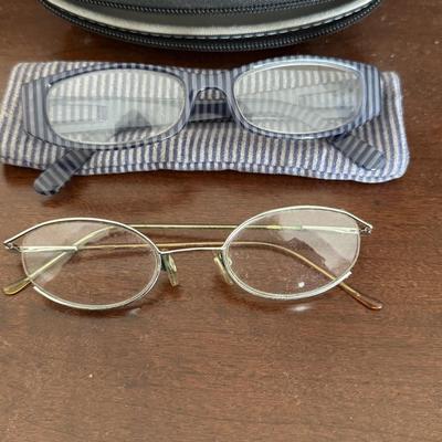 Sunglasses, prescription glasses, and magnifying glass.