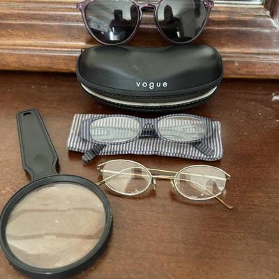 Sunglasses, prescription glasses, and magnifying glass.