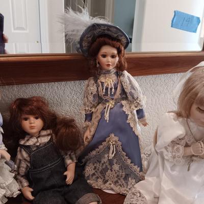 4 PORCELAIN DOLLS