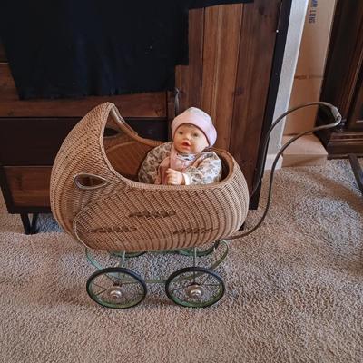 ANTIQUE WICKER BABY STROLLER AND A 1998 CITITOY DOLL