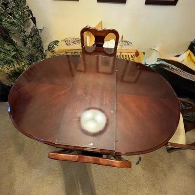 Dining table with four chairs and with a leaf.