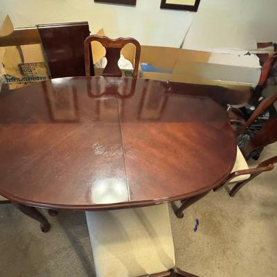 Dining table with four chairs and with a leaf.