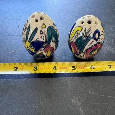 Hand-painted, egg-shaped ceramic salt and pepper shakers.