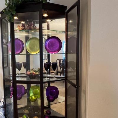 Corner curio cabinet with beautiful decor..