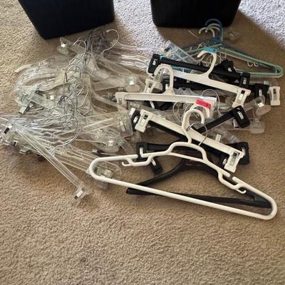 Two trash cans filled with hangers.