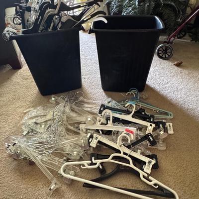 Two trash cans filled with hangers.