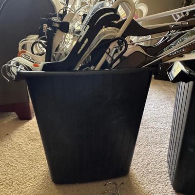Two trash cans filled with hangers.