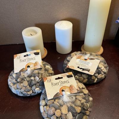Three bags of decorative River Stones and candles.