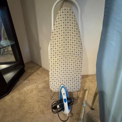 Two ironing boards, one iron.