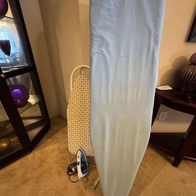 Two ironing boards, one iron.