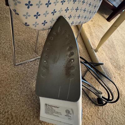 Two ironing boards, one iron.