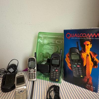 Collection of vintage Qualcomm cellular phones and accessories.