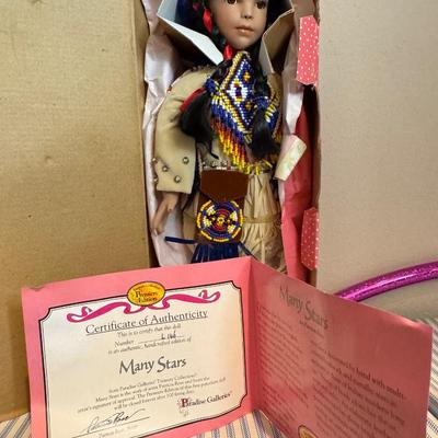 This is a Paradise Galleries porcelain Native American doll and other items.