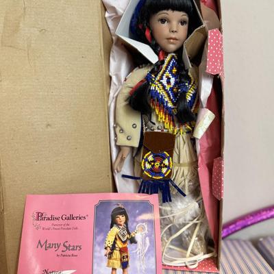 This is a Paradise Galleries porcelain Native American doll and other items.