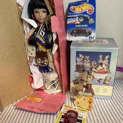 This is a Paradise Galleries porcelain Native American doll and other items.