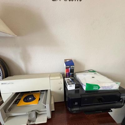 Two printers with printer supplies.
