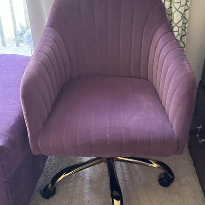 Modern leisure or office chair with a velvet upholstery and a matching ottoman.
