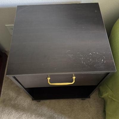 Modern black nightstand with a single drawer and an open lower shelf for storage.