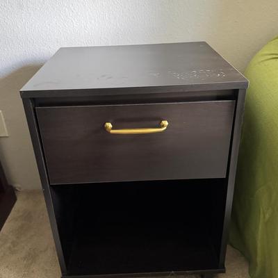 Modern black nightstand with a single drawer and an open lower shelf for storage.