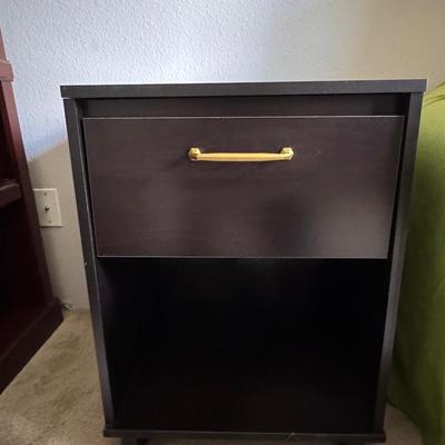 Modern black nightstand with a single drawer and an open lower shelf for storage.