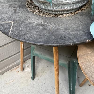 Two round accent or side tables, each holding a large potted plant, identified as a Artificial Philodendron.