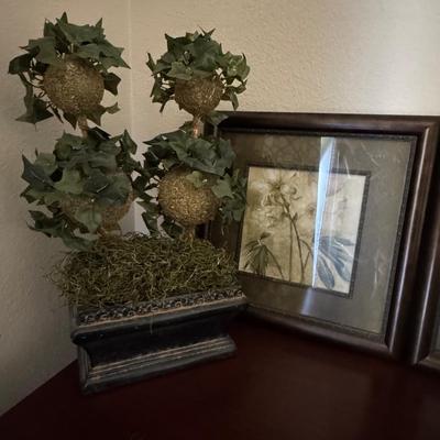 The artworks in the image is a floral print titled "Captive Beauty" by artist Dennis Carney.