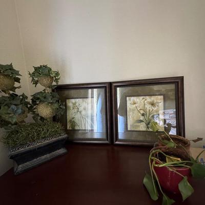 The artworks in the image is a floral print titled "Captive Beauty" by artist Dennis Carney.