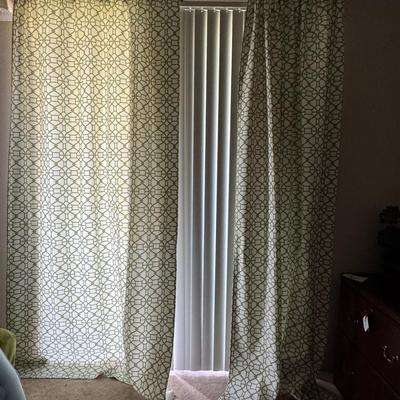 Curtains featuring a geometric pattern that closely resembles the "Buttons" fabric by Linwood, specifically in a light,...