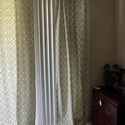 Curtains featuring a geometric pattern that closely resembles the "Buttons" fabric by Linwood, specifically in a light,...