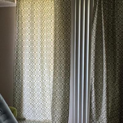 Curtains featuring a geometric pattern that closely resembles the "Buttons" fabric by Linwood, specifically in a light,...