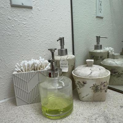 A well-organized bathroom counter, featuring several key accessories.
