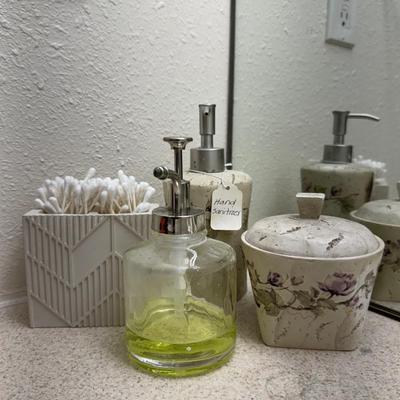 A well-organized bathroom counter, featuring several key accessories.