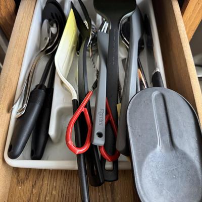 kitchen drawer containing various utensils within a drawer organizer. The brand "Figmint" is visible on one of the utensils.