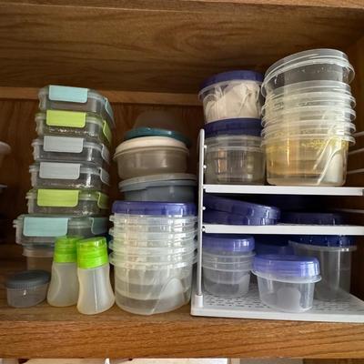 Various food storage containers, primarily plastic, designed for meal prep and general food storage.
