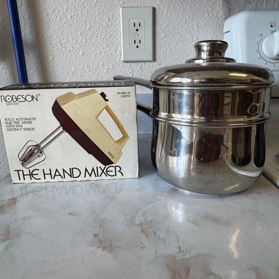 Stainless steel saucepan and a vintage hand mixer in its original box.