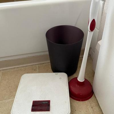 Bathroom scale and plunger and waste basket.