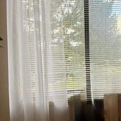 Curtains: These lightweight, translucent curtains provide a soft diffusion of natural light.
