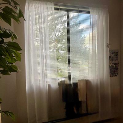 Curtains: These lightweight, translucent curtains provide a soft diffusion of natural light.
