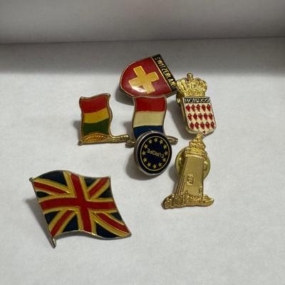 Vintage Borghese Recumbent Lion box and collection of lapel pins.