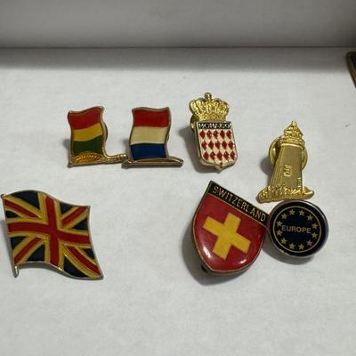 Vintage Borghese Recumbent Lion box and collection of lapel pins.