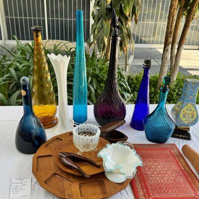 Sale Photo Thumbnail #119: Window large vintage bottle collection , white swung vase. Patterned decanter . Bottle stoppers not matching bottles. Blue Chinese vase with flaws. Teak lazy Susan with "legs" nut cracker and fish box. Patterned gold and red leather portfolio cover. Leath