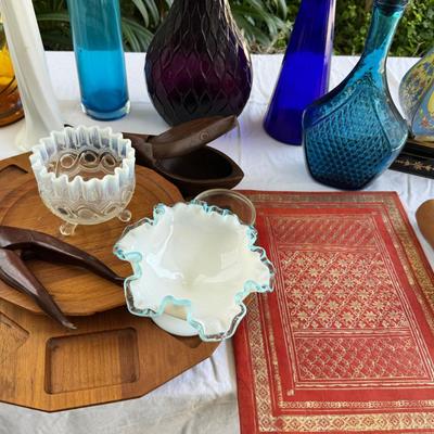 Sale Photo Thumbnail #120: Window large vintage bottle collection , white swung vase. Patterned decanter . Bottle stoppers not matching bottles. Blue Chinese vase with flaws. Teak lazy Susan with "legs" nut cracker and fish box. Patterned gold and red leather portfolio cover. Leath