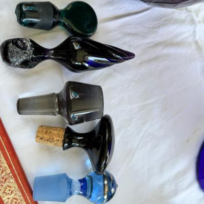 Sale Photo Thumbnail #133: Window large vintage bottle collection , white swung vase. Patterned decanter . Bottle stoppers not matching bottles. Blue Chinese vase with flaws. Teak lazy Susan with "legs" nut cracker and fish box. Patterned gold and red leather portfolio cover. Leath