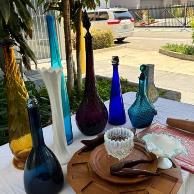 Sale Photo Thumbnail #128: Window large vintage bottle collection , white swung vase. Patterned decanter . Bottle stoppers not matching bottles. Blue Chinese vase with flaws. Teak lazy Susan with "legs" nut cracker and fish box. Patterned gold and red leather portfolio cover. Leath