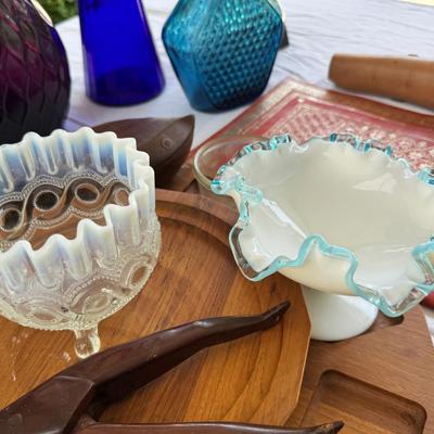 Sale Photo Thumbnail #126: Window large vintage bottle collection , white swung vase. Patterned decanter . Bottle stoppers not matching bottles. Blue Chinese vase with flaws. Teak lazy Susan with "legs" nut cracker and fish box. Patterned gold and red leather portfolio cover. Leath