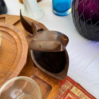 Sale Photo Thumbnail #124: Window large vintage bottle collection , white swung vase. Patterned decanter . Bottle stoppers not matching bottles. Blue Chinese vase with flaws. Teak lazy Susan with "legs" nut cracker and fish box. Patterned gold and red leather portfolio cover. Leath