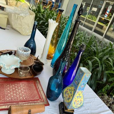 Sale Photo Thumbnail #121: Window large vintage bottle collection , white swung vase. Patterned decanter . Bottle stoppers not matching bottles. Blue Chinese vase with flaws. Teak lazy Susan with "legs" nut cracker and fish box. Patterned gold and red leather portfolio cover. Leath