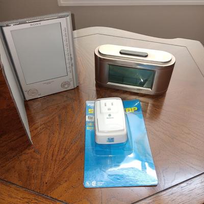 ALARM CLOCK WITH CALENDAR, PORTABLE READER SYSTEM AND A SURGE TAP