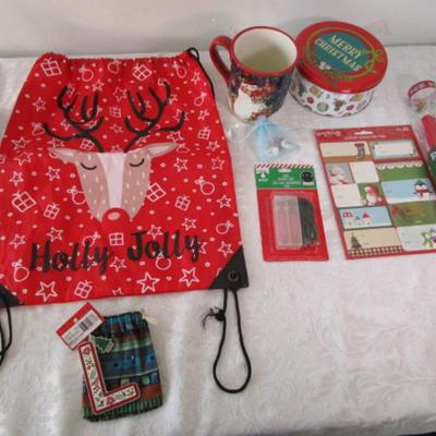 Sale Photo Thumbnail #412: String backpack, mug, Santa earrings, gift labels, new small string of lights (take 2 AA batteries not included), large Pez container, round Christmas tin, 2 ornaments