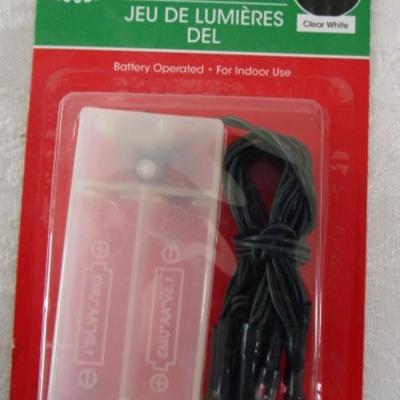 Sale Photo Thumbnail #417: String backpack, mug, Santa earrings, gift labels, new small string of lights (take 2 AA batteries not included), large Pez container, round Christmas tin, 2 ornaments